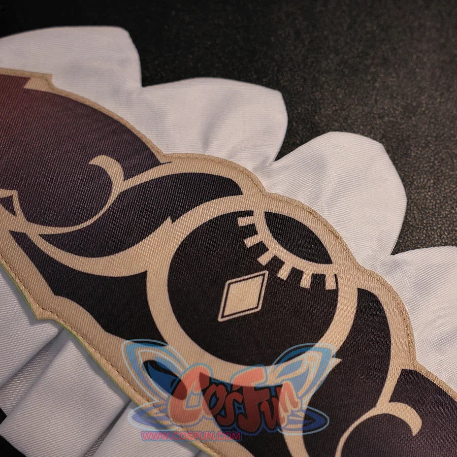 Close-up of Sandrone cosplay costume skirt pattern with black printed motif, beige trim, and white scalloped edge