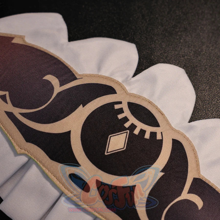 Close-up of Sandrone cosplay costume skirt pattern with black printed motif, beige trim, and white scalloped edge