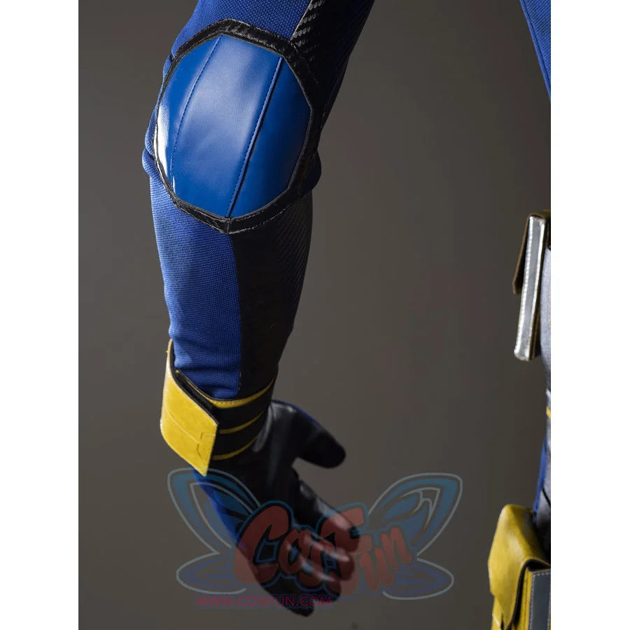 Scott Summers cosplay sleeve detail frames a blue elbow pad in black trim above the yellow wristband.