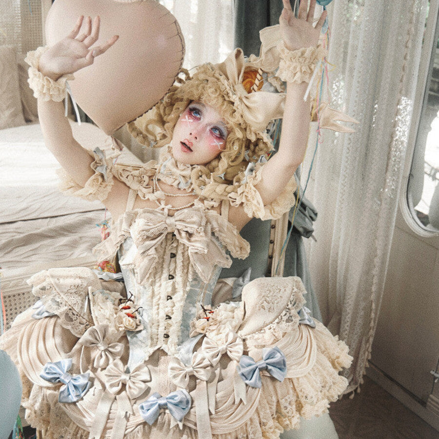 Seated styling showing the cream Rococo corset top with lace ruffles and blue accents