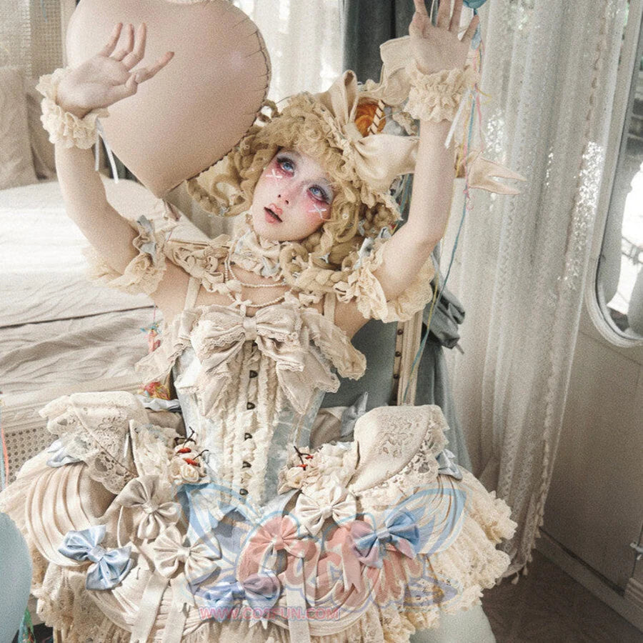 Seated styling showing the cream Rococo corset top with lace ruffles and blue accents