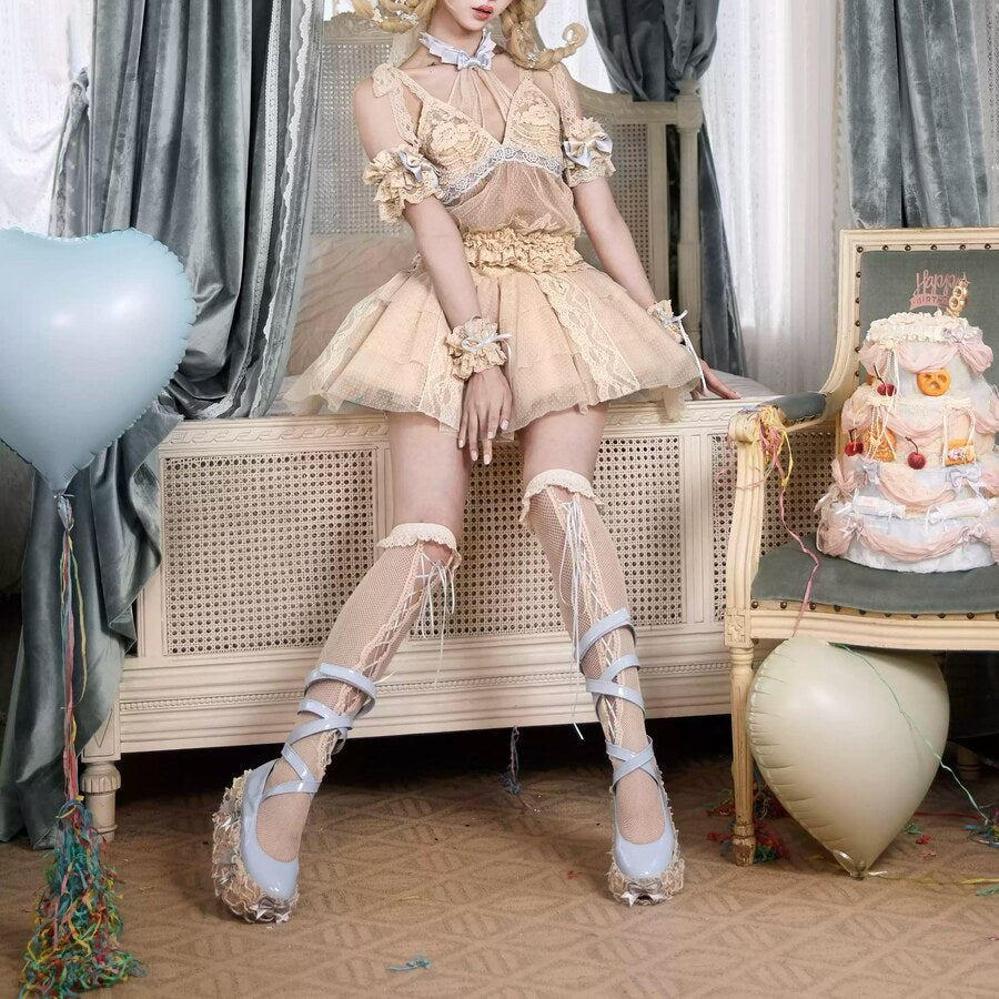 Seated Rococo Lolita styling with a beige lace skort and soft cream accessories