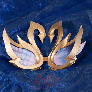 Genshin Impact Snezhnaya Odette cosplay costume swan prop close-up pairs gold-tone wings beside glossy blue panels.