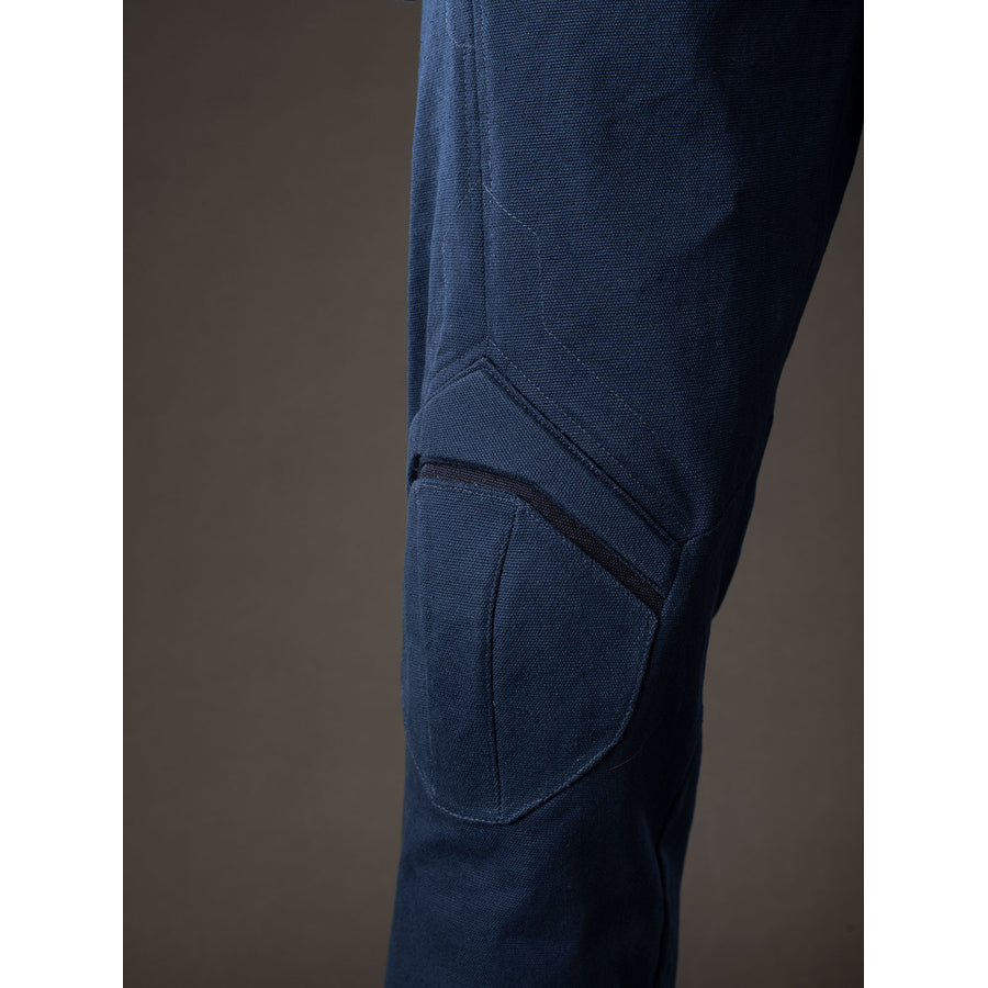 Steve Rogers cosplay knee armor close-up sets raised navy padding along the trouser leg.