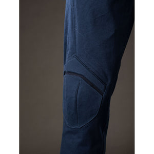 Steve Rogers cosplay knee armor close-up sets raised navy padding along the trouser leg.