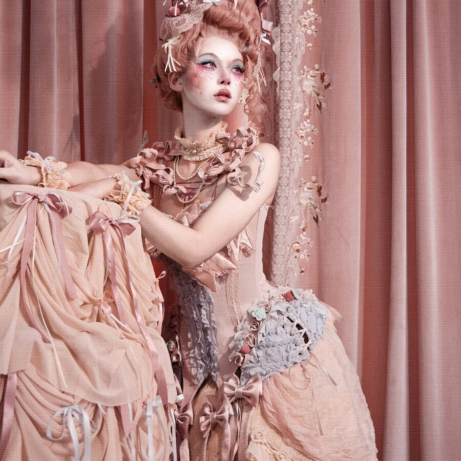 Seated Cream Oracle styling with the pink corset top and ruffled skirt coordinate