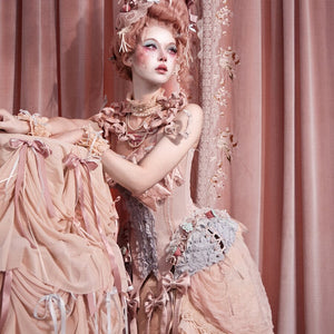 Seated Cream Oracle styling with the pink corset top and ruffled skirt coordinate