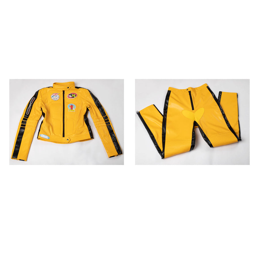 Flat lay of The Bride cosplay costume with yellow jacket, pants, black side stripes and heart-shaped front panel