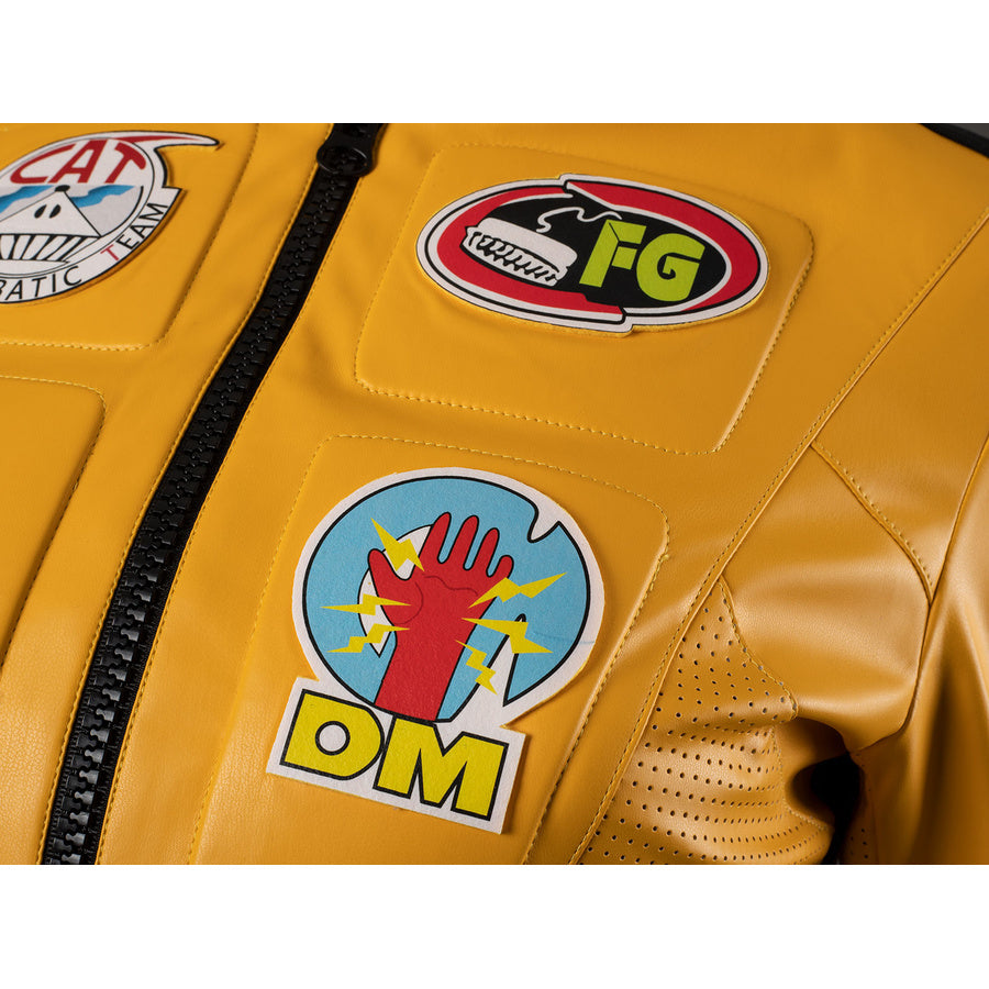 Close-up of The Bride cosplay jacket chest badges with FG, DM hand and team emblems on yellow PU leather