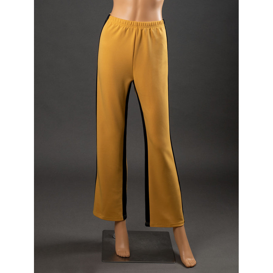 Front view of The Bride Cosplay pants with elastic waistband, straight yellow legs, black side stripes and stitched hems