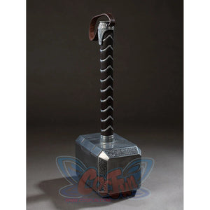 Thor cosplay hammer sets a heavy metallic block base beneath a patterned handle that secures with a faux leather wrist loop.