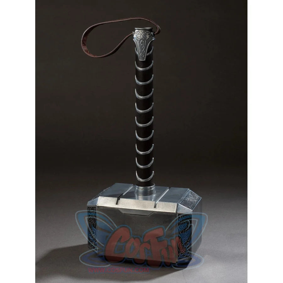 Thor cosplay hammer centers heavy rectangular metal hammer head with intricate side engravings and a long cylindrical handle.
