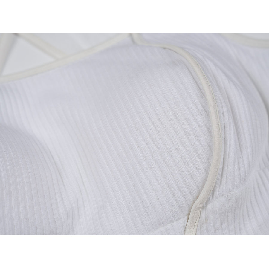 Tifa cosplay costume traces the soft texture of the white ribbed knit top through smooth faux leather edge bindings.