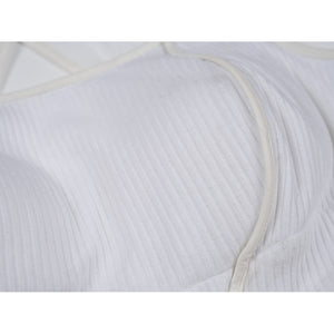 Tifa cosplay costume traces the soft texture of the white ribbed knit top through smooth faux leather edge bindings.