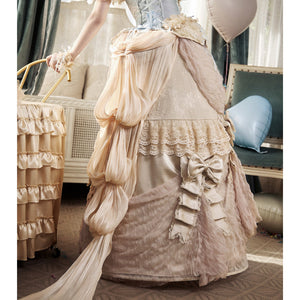 Rear styling view with a long trailing train, lace ruffles, and bow ties