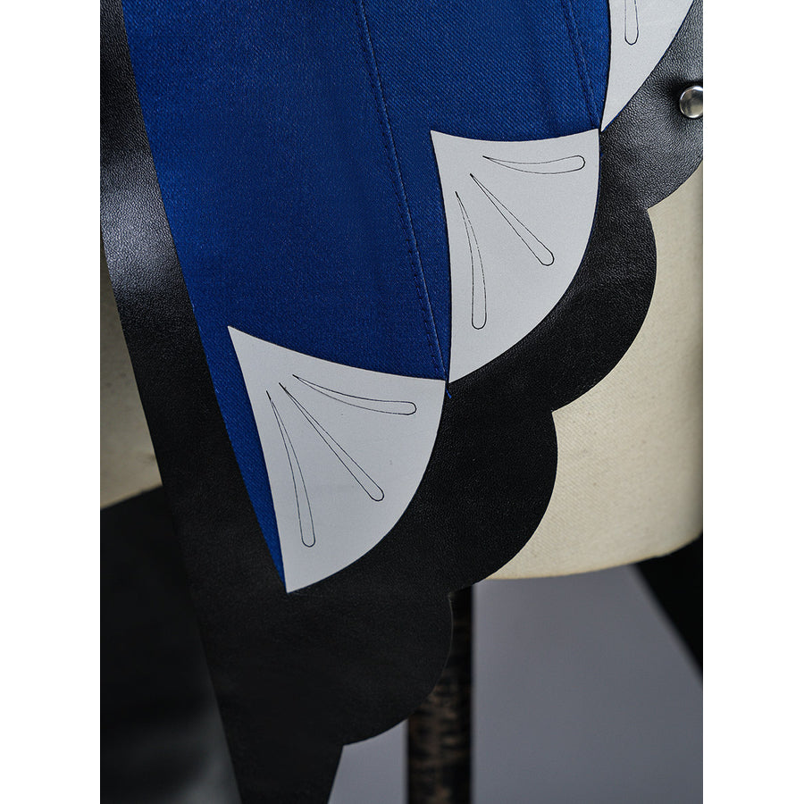 Velina Airgid cosplay skirt panel detail shows blue and white scalloped layers over the black train.