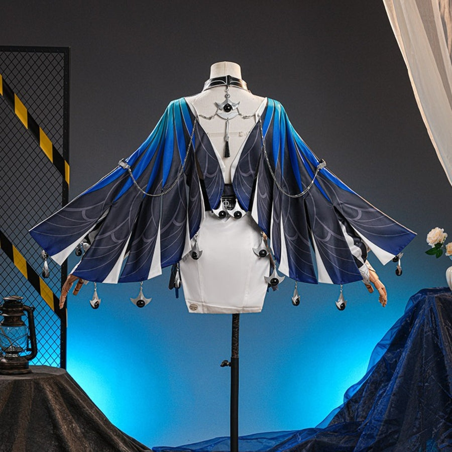Velina Airgid cosplay costume drapes a blue gradient capelet over a white dress with intricate metal chain and bead details.