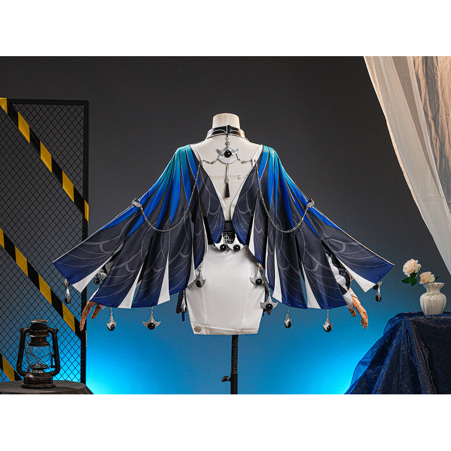 Velina Airgid cosplay costume centers blue and black gradient capelet with silver-tone chain accents over a white strapless.