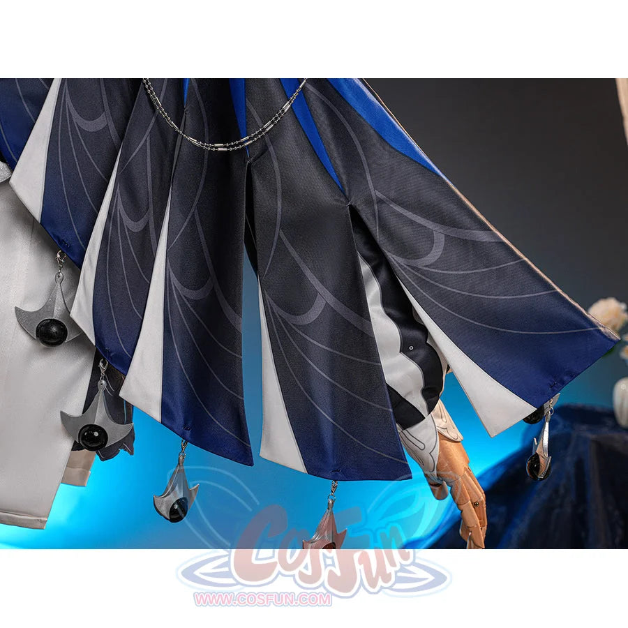 Velina Airgid cosplay costume centers pleated capelet fabric with printed patterns and hanging silver-tone charms.