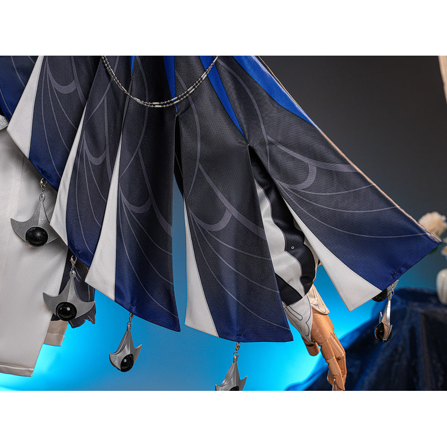 Velina Airgid cosplay costume centers pleated capelet fabric with printed patterns and hanging silver-tone charms.