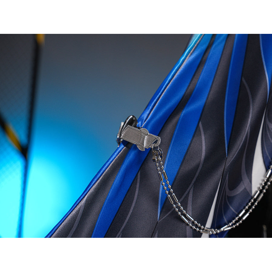 Velina Airgid cosplay costume anchors a metallic silver-tone chain to the pleated blue and dark grey patterned fabric panels.