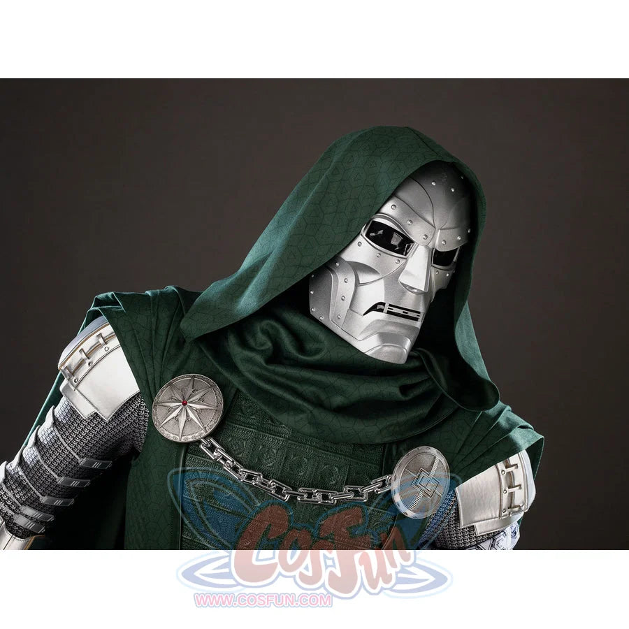 Victor Von Doom cosplay costume frames the metallic mask under a green hood between chain and cape brooches.