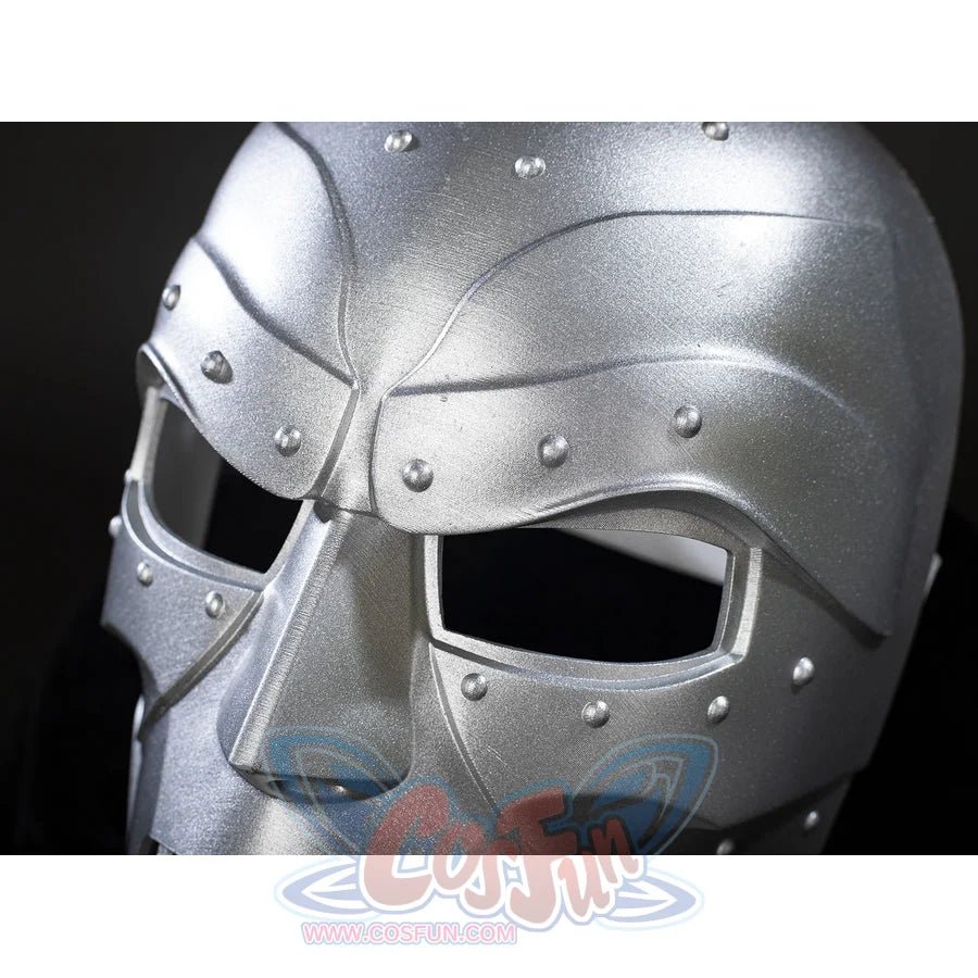 Victor Von Doom cosplay mask close-up frames angular eye openings beneath raised riveted brow plates.