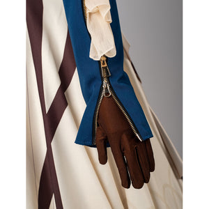 Violet Evergarden cosplay costume sleeve detail frames a blue zipper cuff above a brown glove.