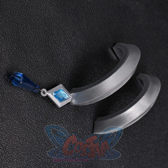 Vodyanitsa cosplay earrings flat lay with curved silver-tone forms and blue hanging accents.