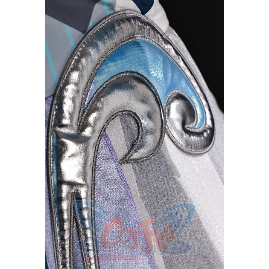 Vodyanitsa cosplay costume trim detail with raised silver-tone scrollwork beside pale blue and gray layers.