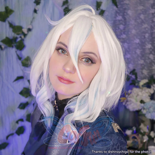 Genshin Impact Furina cosplay wig balances a white wavy bob beside a dark blue jacket with gold accent detail.