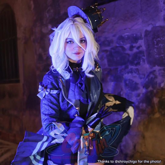 Genshin Impact Furina cosplay outfit centers a gold crown hat above a ruffled collar and blue brocade jacket.