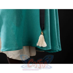 Witch Hat Atelier Coco Tetia Richeh cosplay cloak hem detail hangs a pale tassel beside teal fabric.