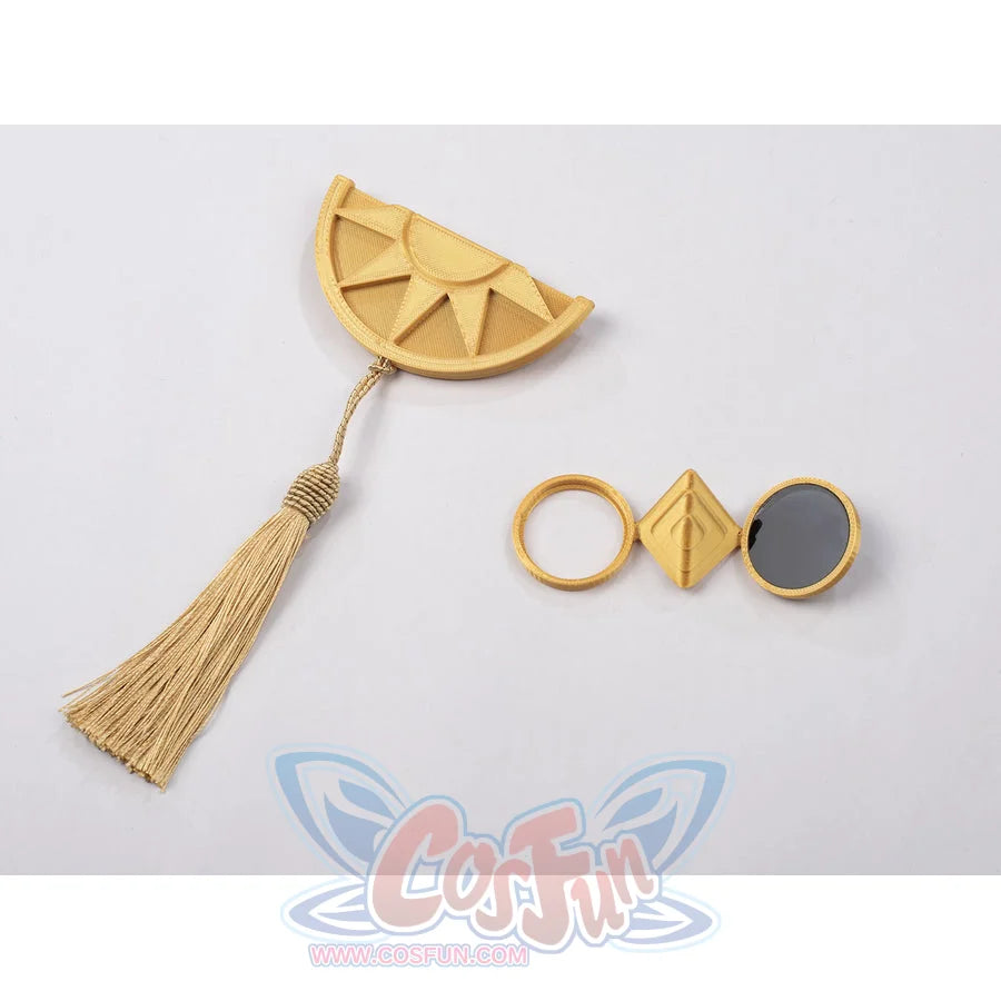 Witch Hat Atelier Qifrey cosplay accessory flat lay pairs the gold-tone brooch, tassel, and glasses.