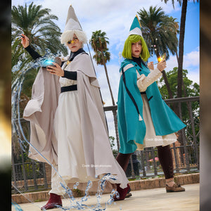 Witch Hat Atelier Qifrey and Coco cosplay costumes pair pale and teal capes over matching apprentice robes.