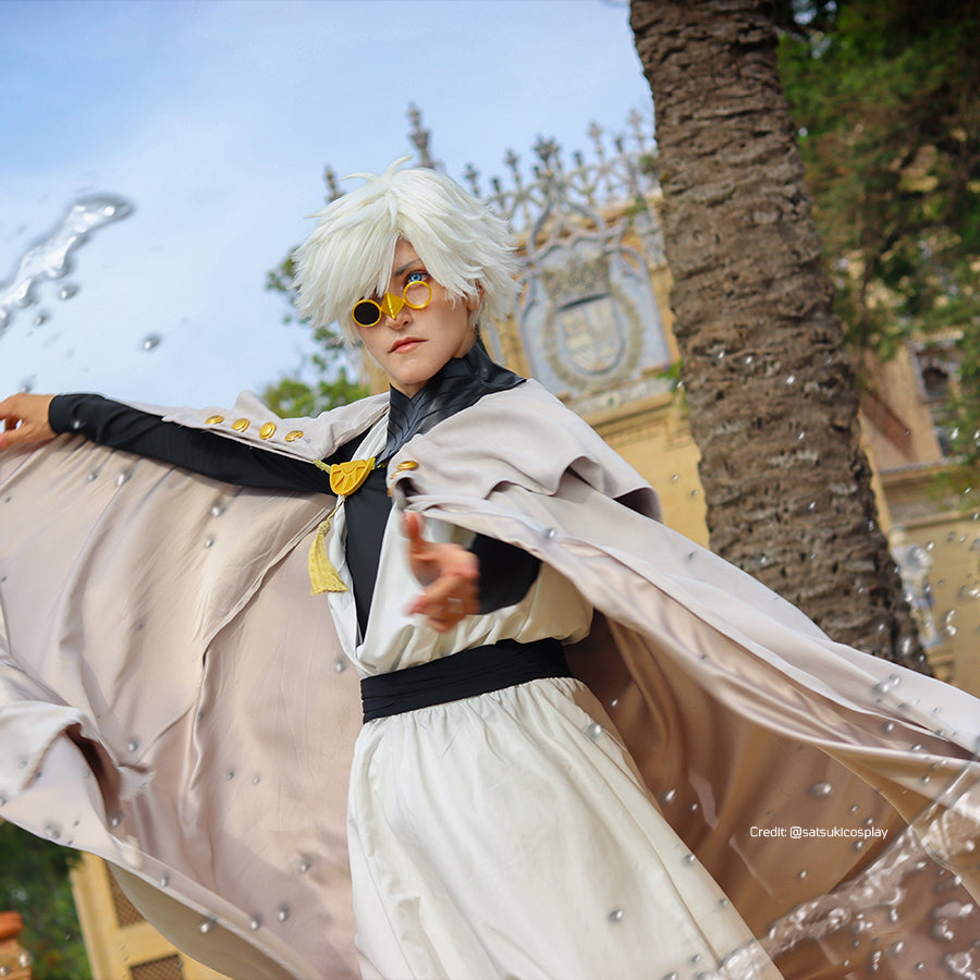 Witch Hat Atelier Qifrey cosplay costume action view spreads the pale cape around a white robe and black belt.