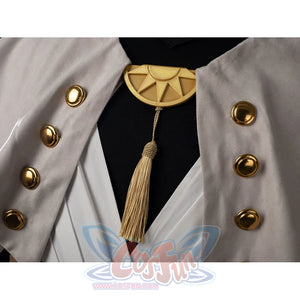 Witch Hat Atelier Qifrey cosplay brooch detail hangs a tassel below gold-tone buttons and folded robe panels.