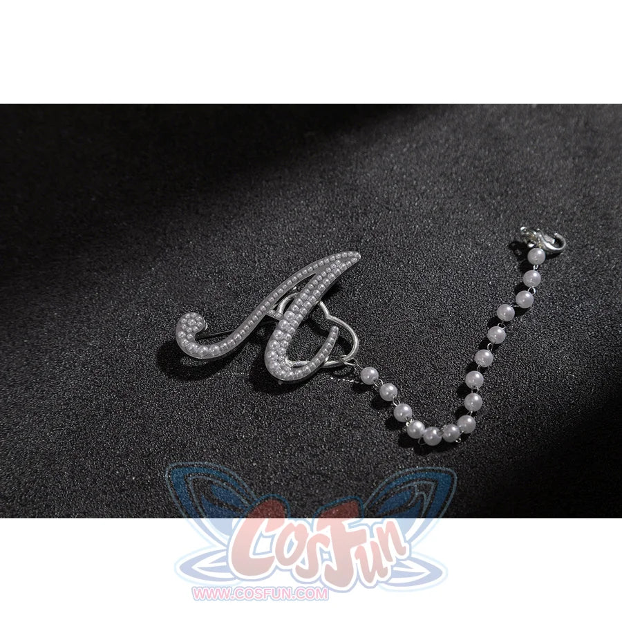 Wuthering Waves Aemeath cosplay arm chain charm detail pairs a silver-tone letter accent with a beaded strand.