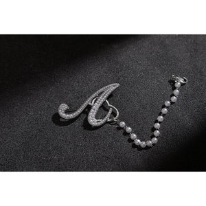 Wuthering Waves Aemeath cosplay arm chain charm detail pairs a silver-tone letter accent with a beaded strand.