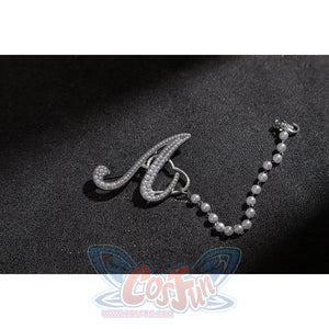 Wuthering Waves Aemeath cosplay arm chain charm detail pairs a silver-tone letter accent with a beaded strand.