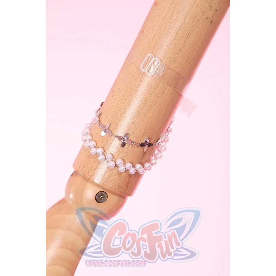 Wuthering Waves Aemeath cosplay arm chain detail drapes pearl-like beads and star charms beside a clear arm ring.