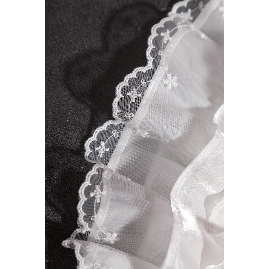 Wuthering Waves Aemeath cosplay lace edge detail traces embroidered flowers along a sheer white ruffle.