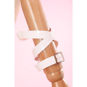 Wuthering Waves Aemeath cosplay leg ring detail crosses white straps around a buckle and layered band.