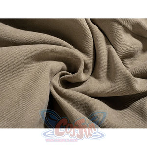 Yoda Master cosplay costume layers soft beige knit fabric in deep flowing folds to frames the texture of the material.