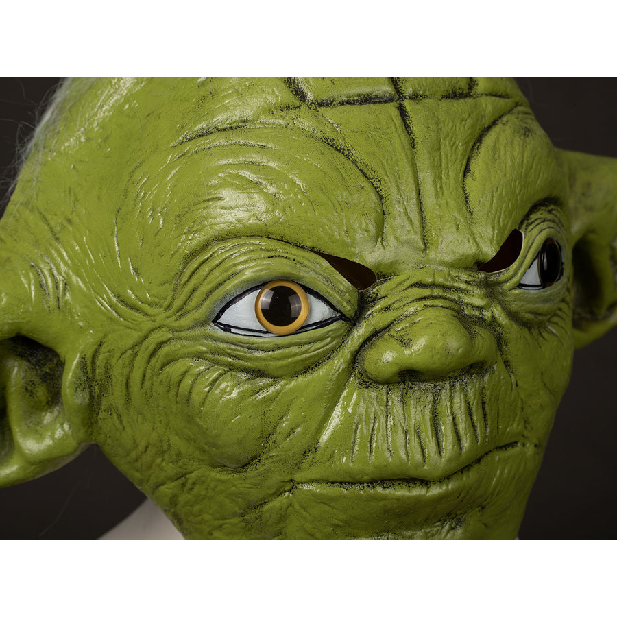 Yoda Master cosplay headpiece and claws curve across wrinkled green latex facial pairs with realistic gold-tone eyes.