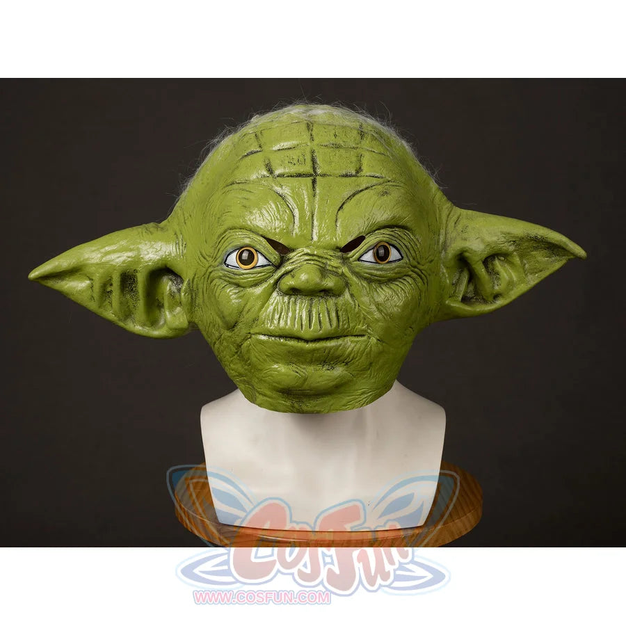 Yoda Master cosplay headpiece and claws curve into a textured green latex mask with intricate skin wrinkles and wide ears.