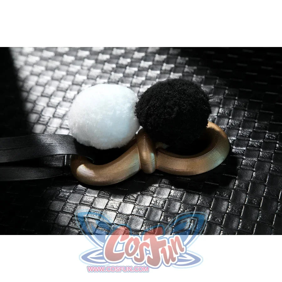 Zenless Zone Zero Dialyn cosplay pom accessory flat lay places black and white pom pieces beside a gold ring