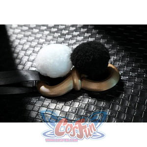 Zenless Zone Zero Dialyn cosplay pom accessory flat lay places black and white pom pieces beside a gold ring