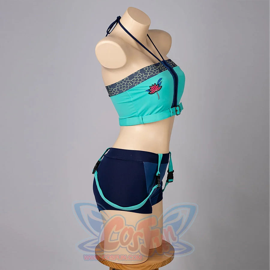 Zoey cosplay tankini side-back view sets a teal cropped top above navy shorts and turquoise straps.
